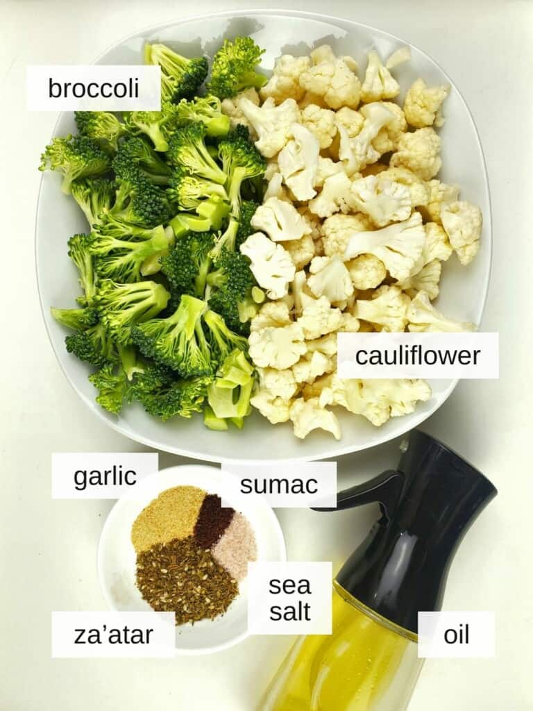 ingredients for air fryer broccoli and cauliflower, including broccoli, cauliflower, garlic, sumac, za'atar, sea salt, and oil.