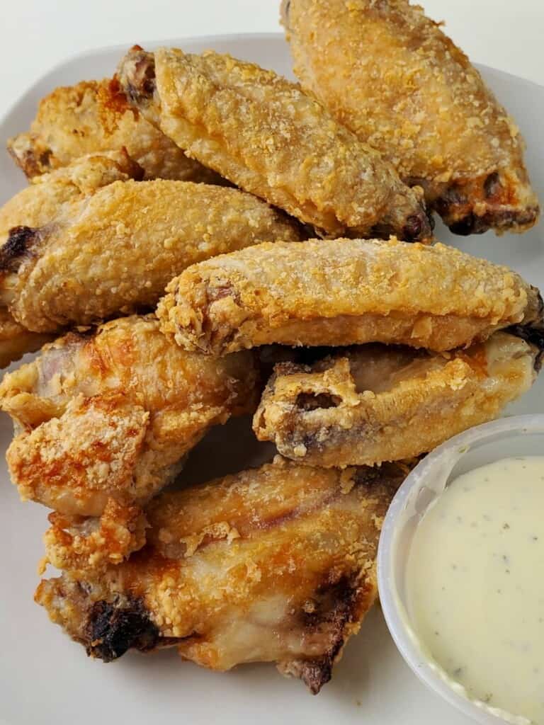 air fried chicken wings with sauce on a plate.