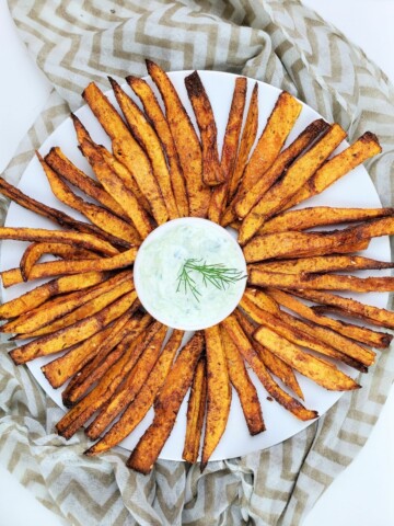 air fried butternut squash fries with dipping sauce on a white plate.