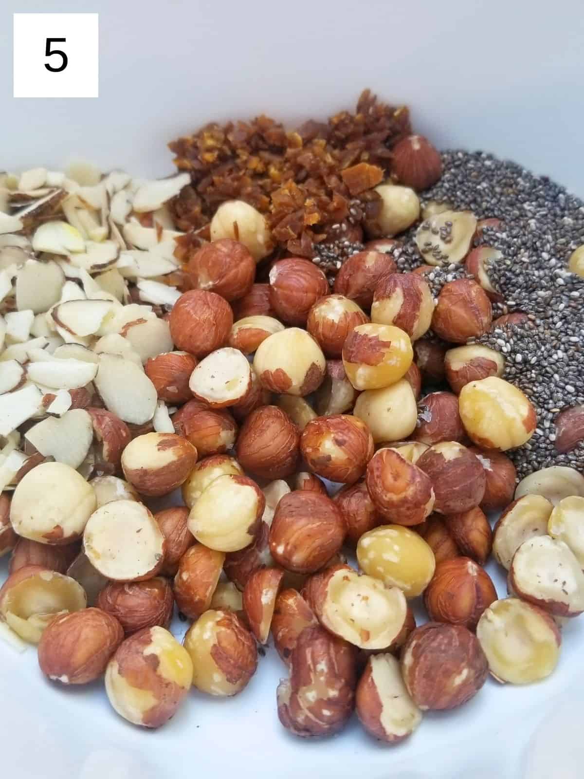 mixing all of the hazelnut crunch cluster ingredients in a bowl.