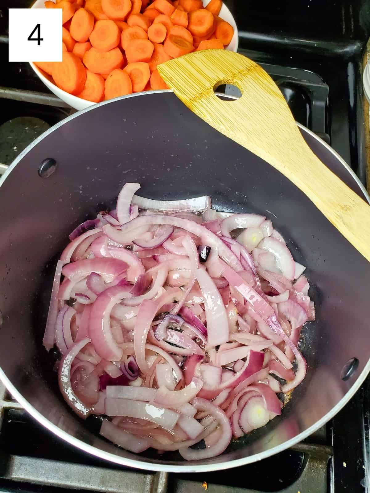 sautéing the chopped onions in a pot until transluscent.