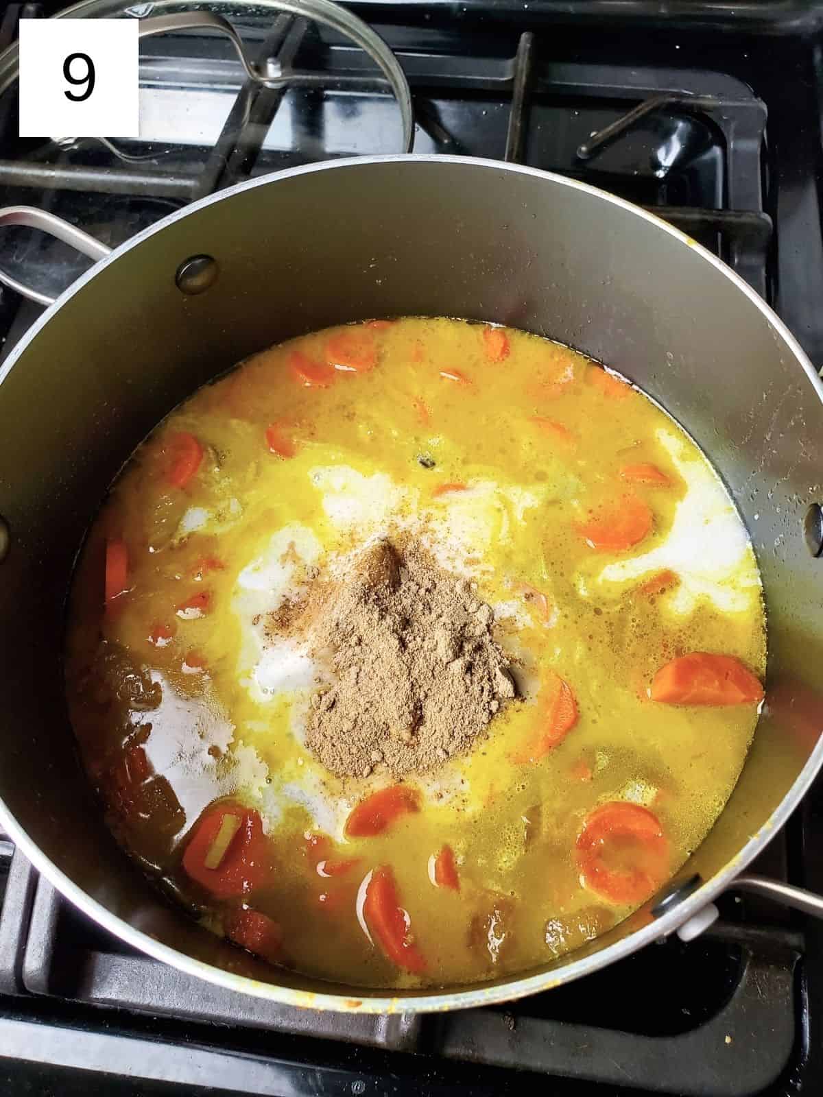coconut milk, amchur, and salt in a pot of carrots and stock mixture.