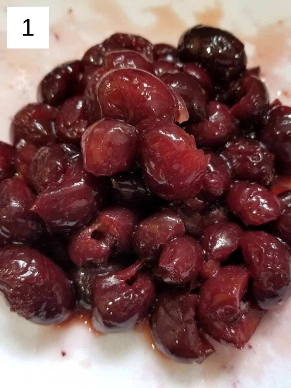 sliced cherries on a chopping board.