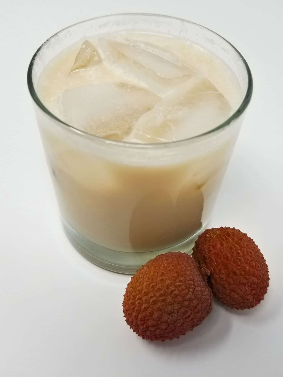 coconut lychee mocktail in a glass served with ice.