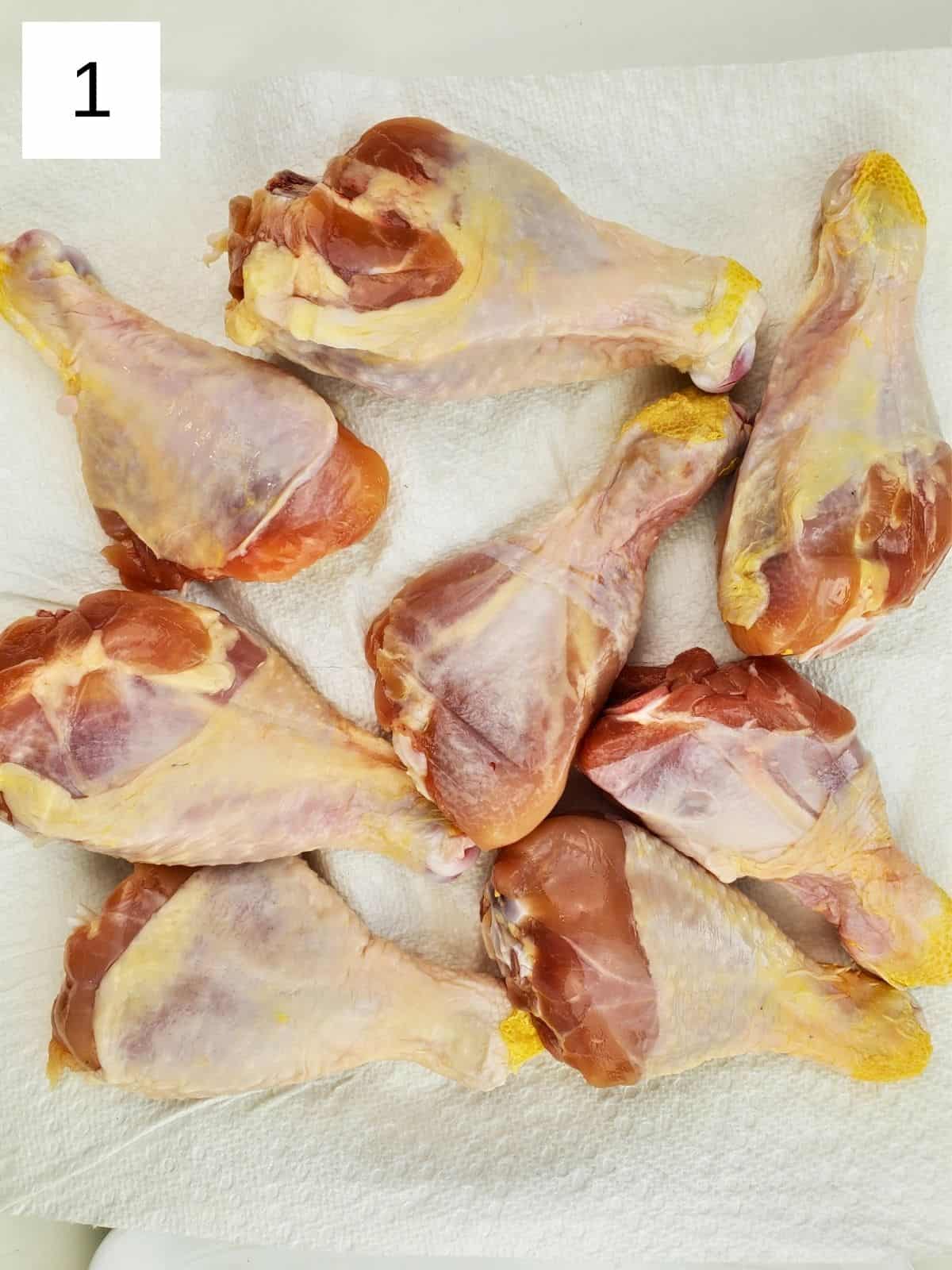 raw eight pieces of chicken legs on a kitchen towel.