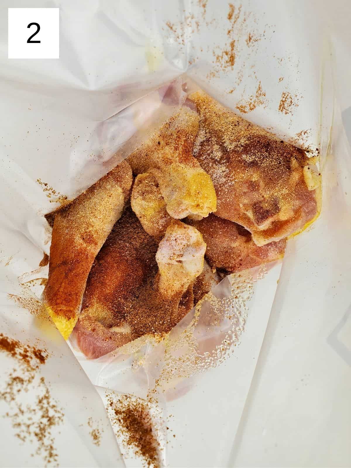 raw chicken legs, seasoned with salt, sumac, garlic powder, paprika, and sugar, on a ziploc freezer bag.
