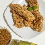 grain-free chicken tenders on a plate and a jar of za'atar spice blend.