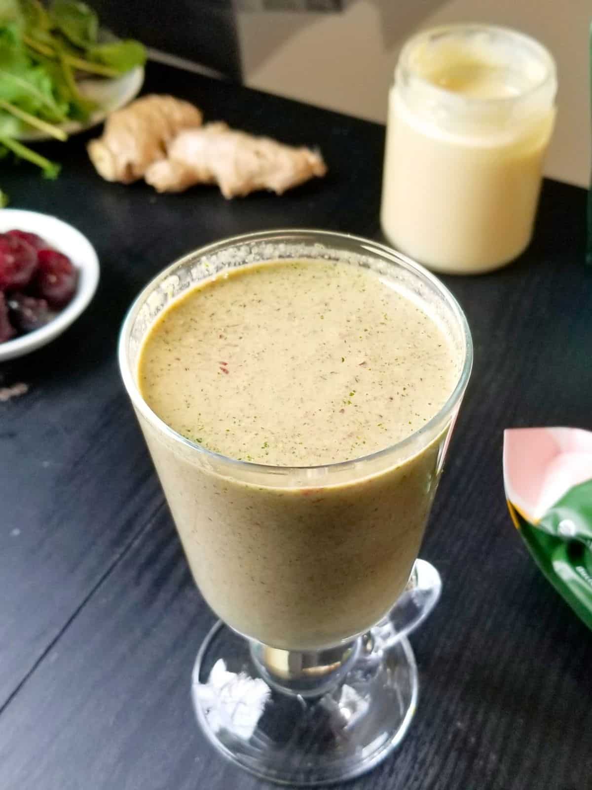 a glass of iron-rich smoothie with cherries and baby kale.