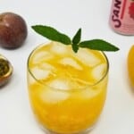 mango passion fruit mocktail on a drinking glass served with ice.