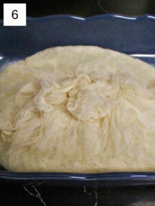 cheesecloth-wrapped sticky rice in a container.