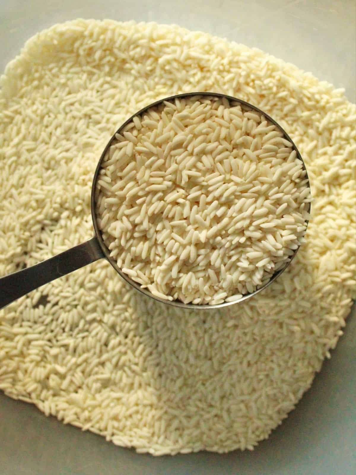 raw sweet rice in a measuring cup.