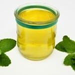 mint simple syrup in a glass.