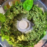 a blend of basil, garlic, and nuts in a food processor.