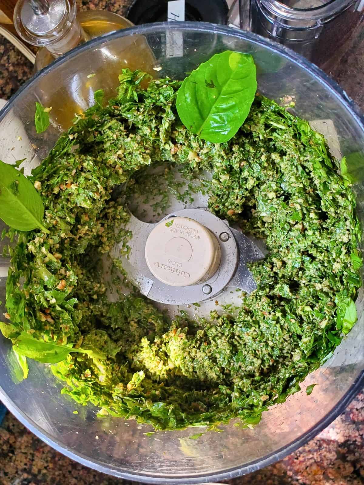 a blend of basil, garlic, and nuts in a food processor.