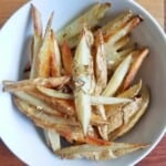 baked French fries, seasoned with rosemary garlic, in a bowl.