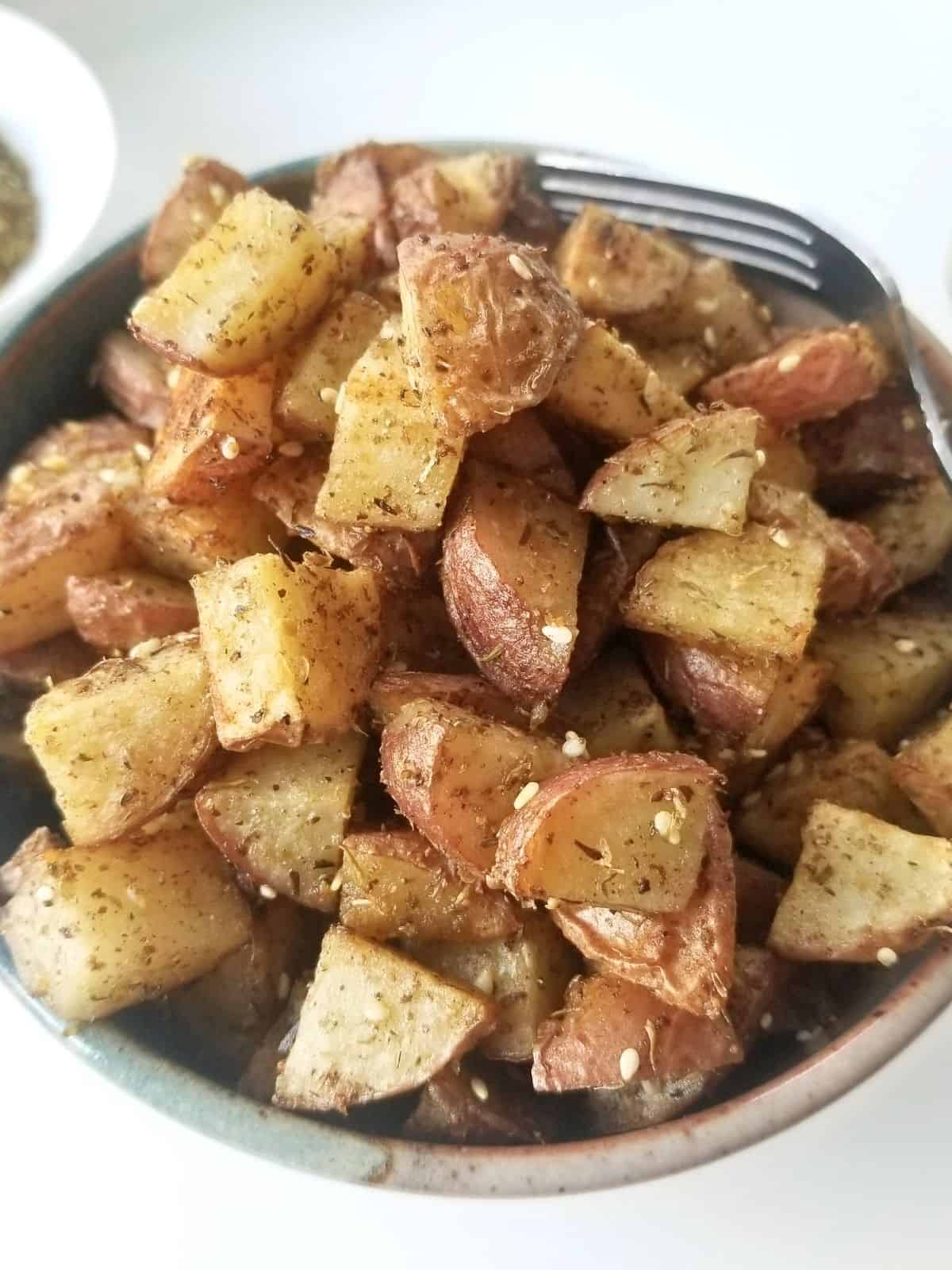 roasted potatoes, seasoned with za'atar, in a bowl.