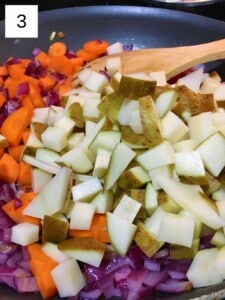 cooking the carrots and potatoes with the onion and garlic in a skillet.