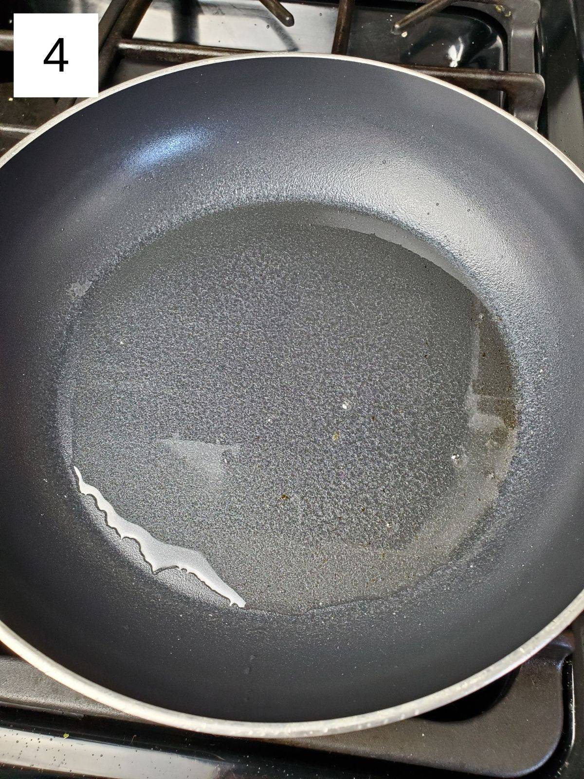 oil-coated pan on a stove.