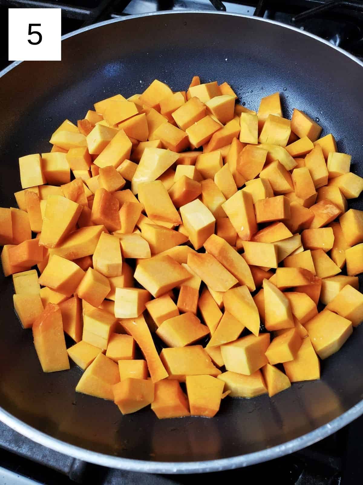 butternut squash cubes on a heated oil-coated pan.