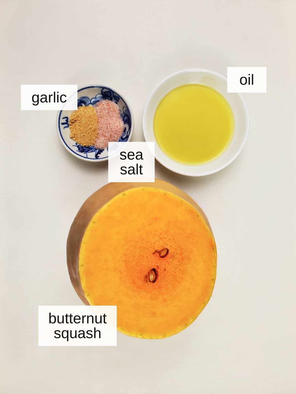 ingredients for savory sautéed butternut squash, including garlic powder, sea salt, oil, and butternut squash.