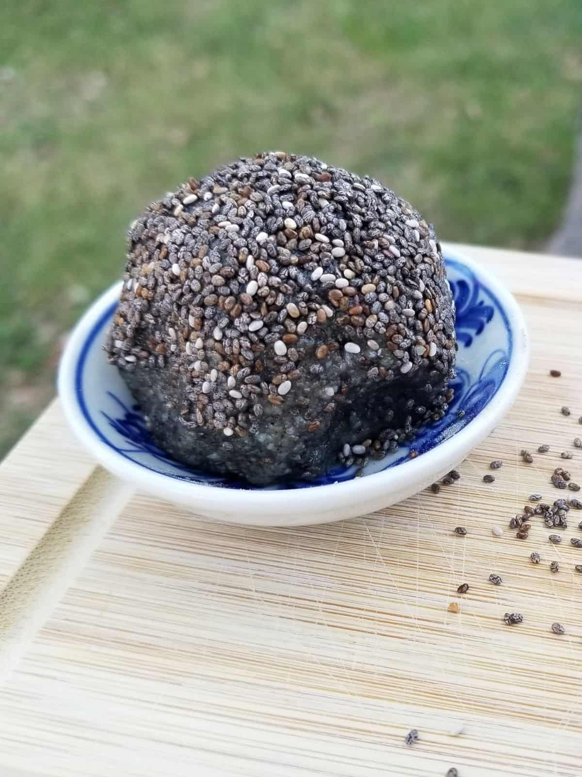 ginger tahini protein ball, coated with chia seeds.