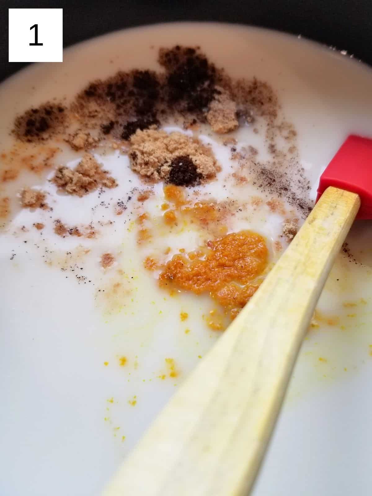 adding a variety of spices to milk in a saucepan.