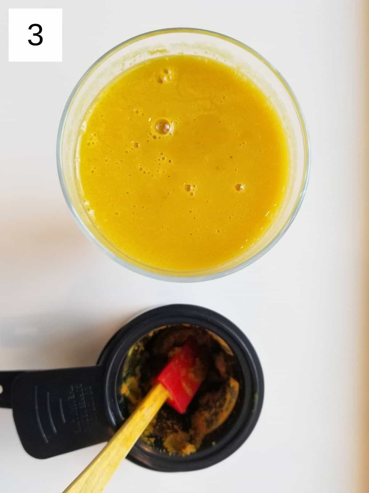 strained golden milk latte in a drinking glass.