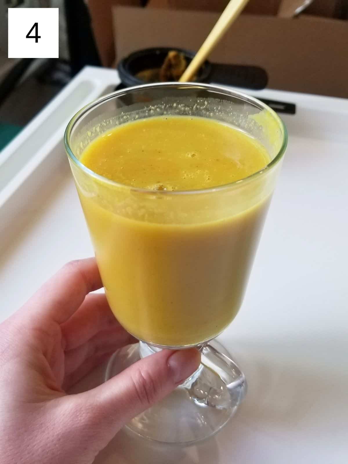 golden/turmeric milk latte in a drinking glass.