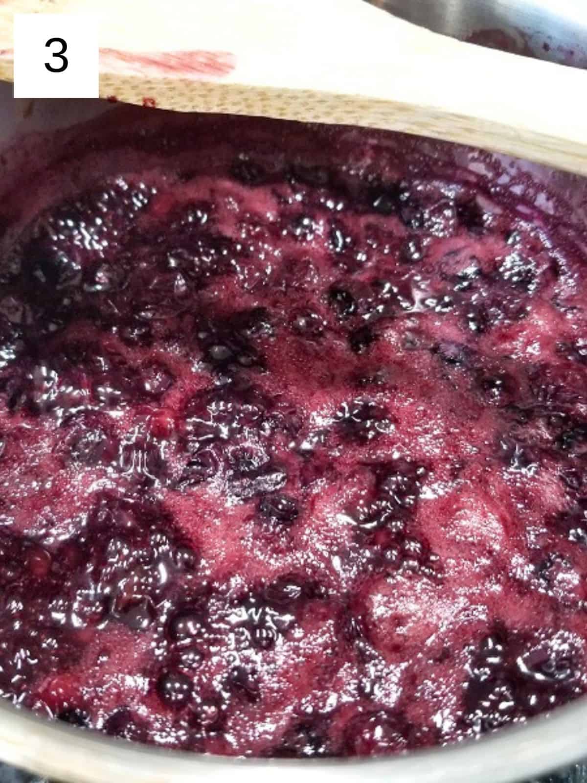 crushed and soften blueberry mixture in a pot.