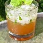virgin mint julep mocktail in a glass topped with fresh mint leaves.