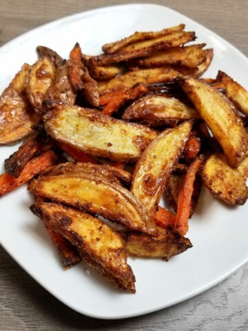air fried potatoes and carrots, seasoned with maple garlic, in a plate.