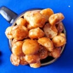 candied macadamia nuts in a mug.