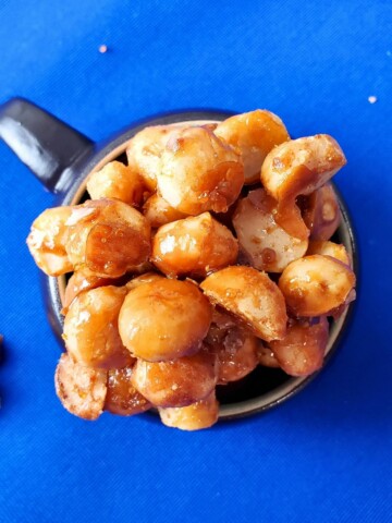 candied macadamia nuts in a mug.