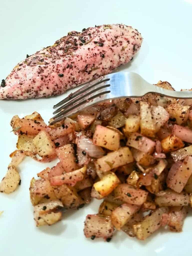 cooked onion and sumac chicken with potatoes in a plate.