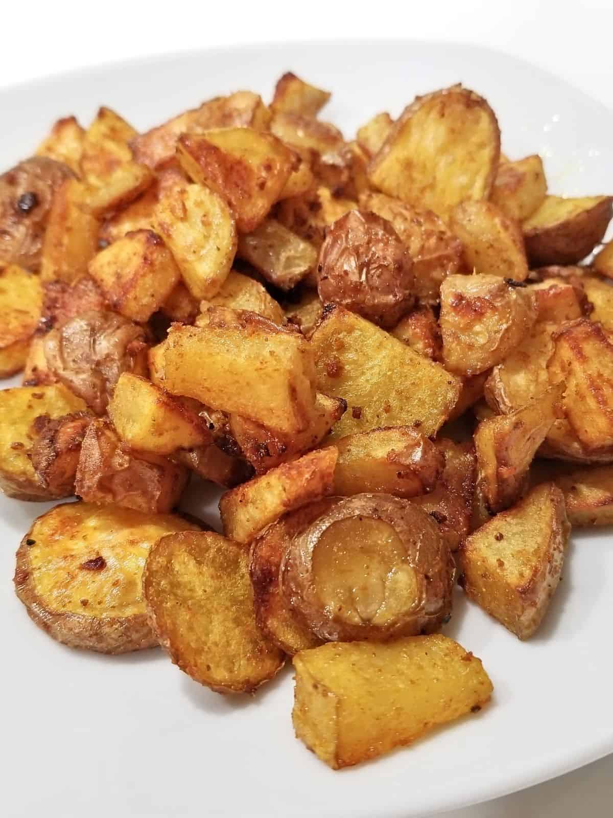 roasted turmeric potatoes in a plate.