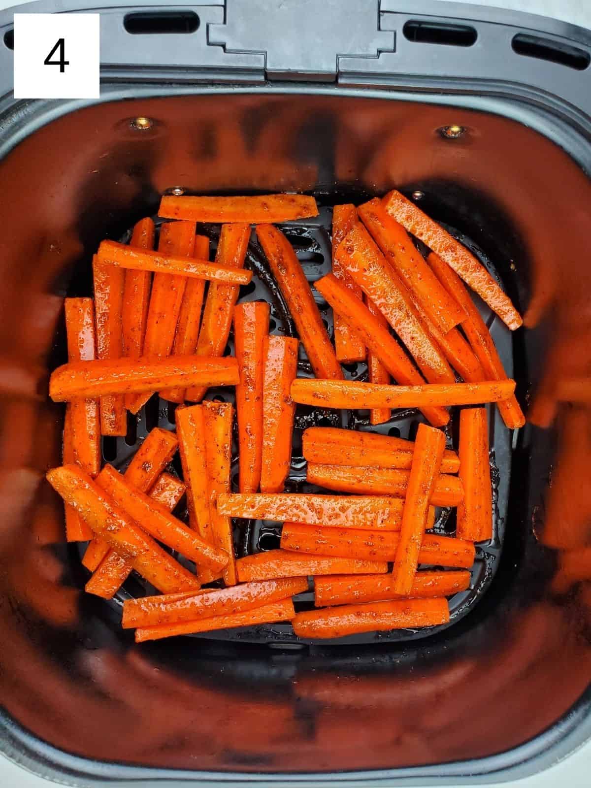 seasoned carrots slices in an air fryer.