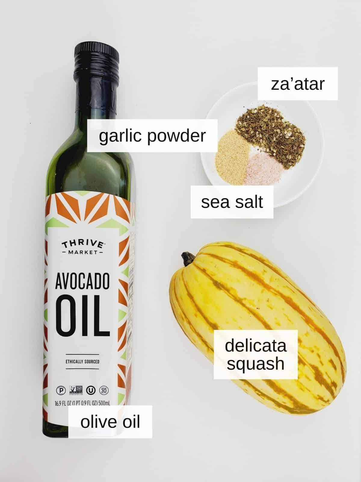ingredients for delicata squash fries, including delicata, avocado oil sea salt, garlic, and zata'ar spices.