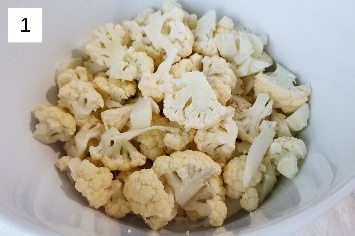 Raw cauliflower florets in a bowl.