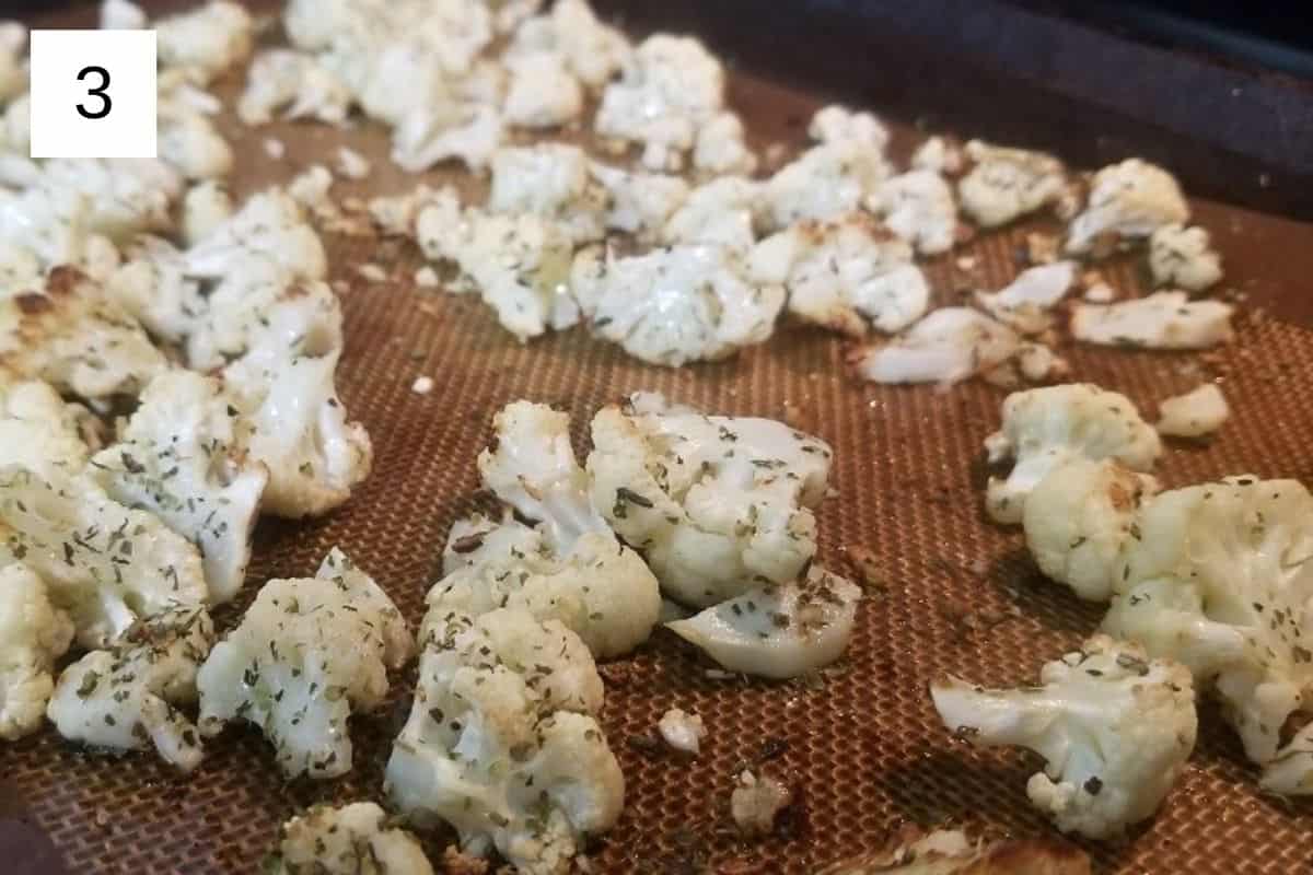 Baked cauliflower florets on a baking tray.