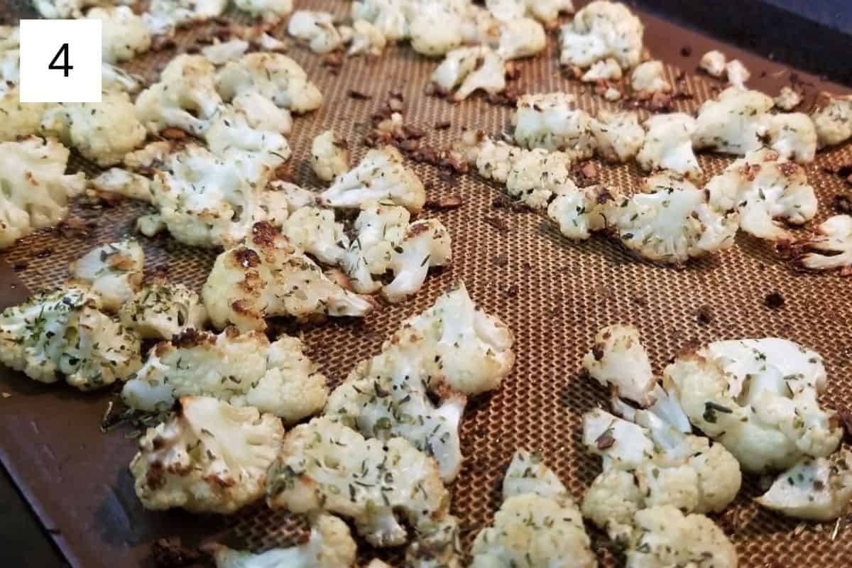Baked cauliflower florets on a baking tray.