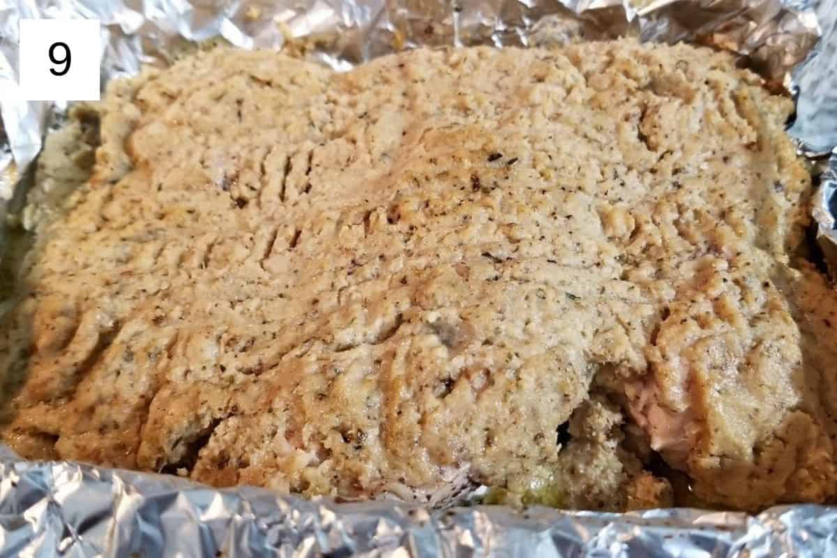 A mixture of baked chicken and cauliflower, flattened on a baking tray.