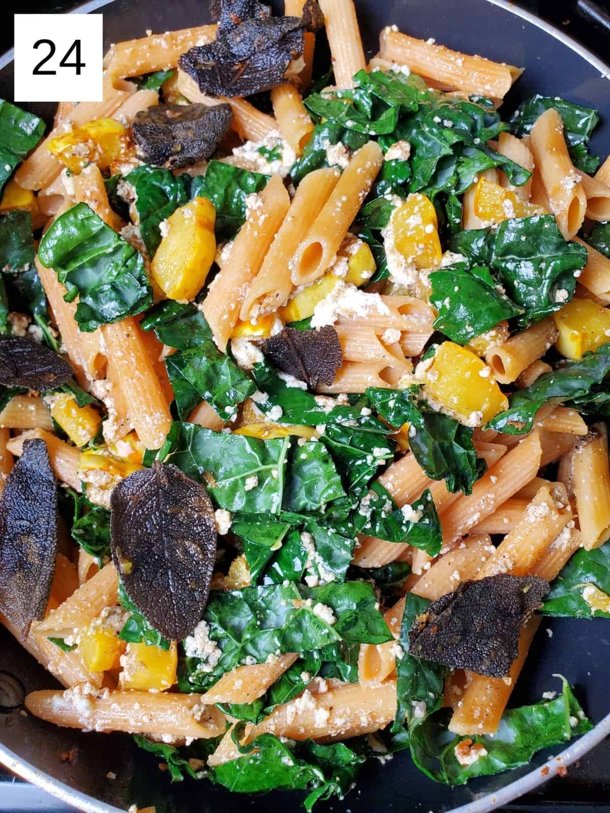 cooked delicata squash pasta with sage butter, ricotta cheese, and kale leaves.