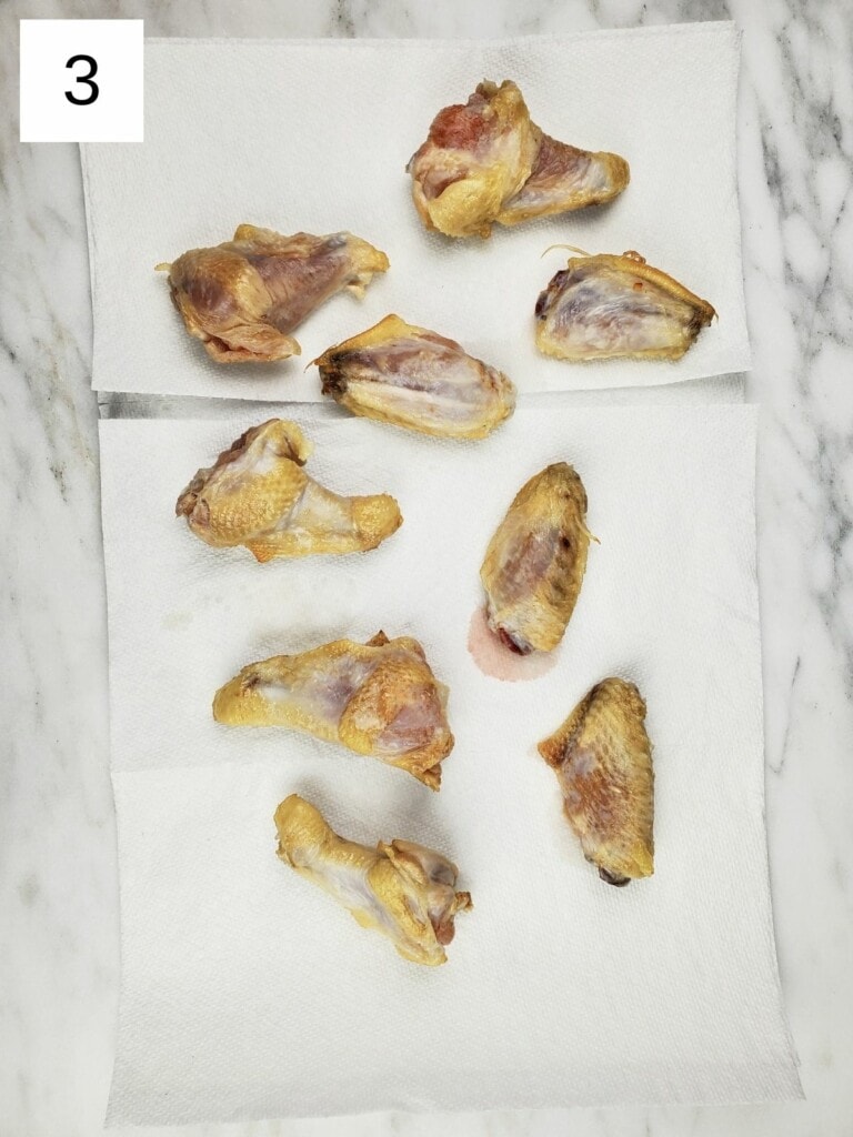 individual chicken wings on top of several paper towels.
