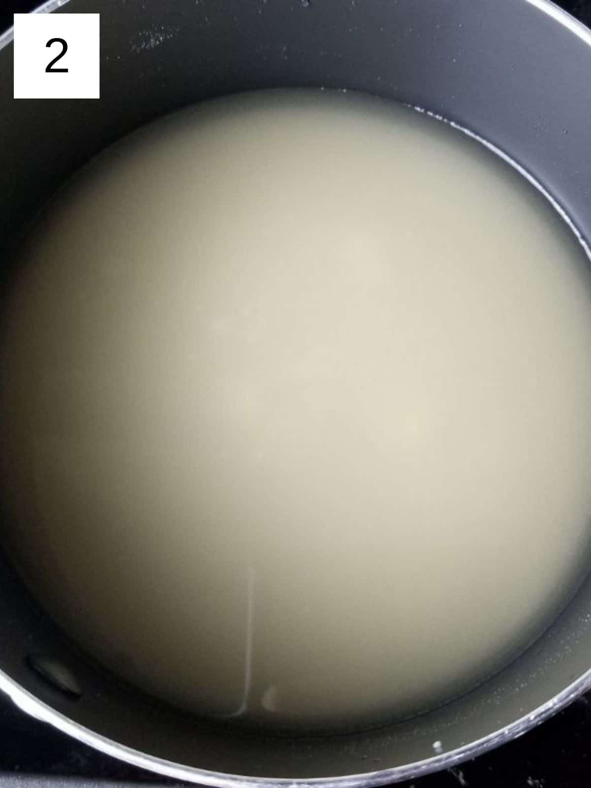 a mixture of water and sweetener in a metal pan.