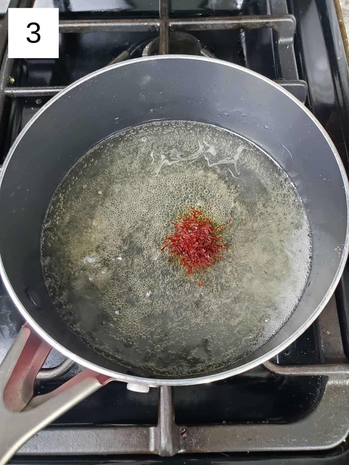 a pinch of saffron in a pan of sugar mixture.