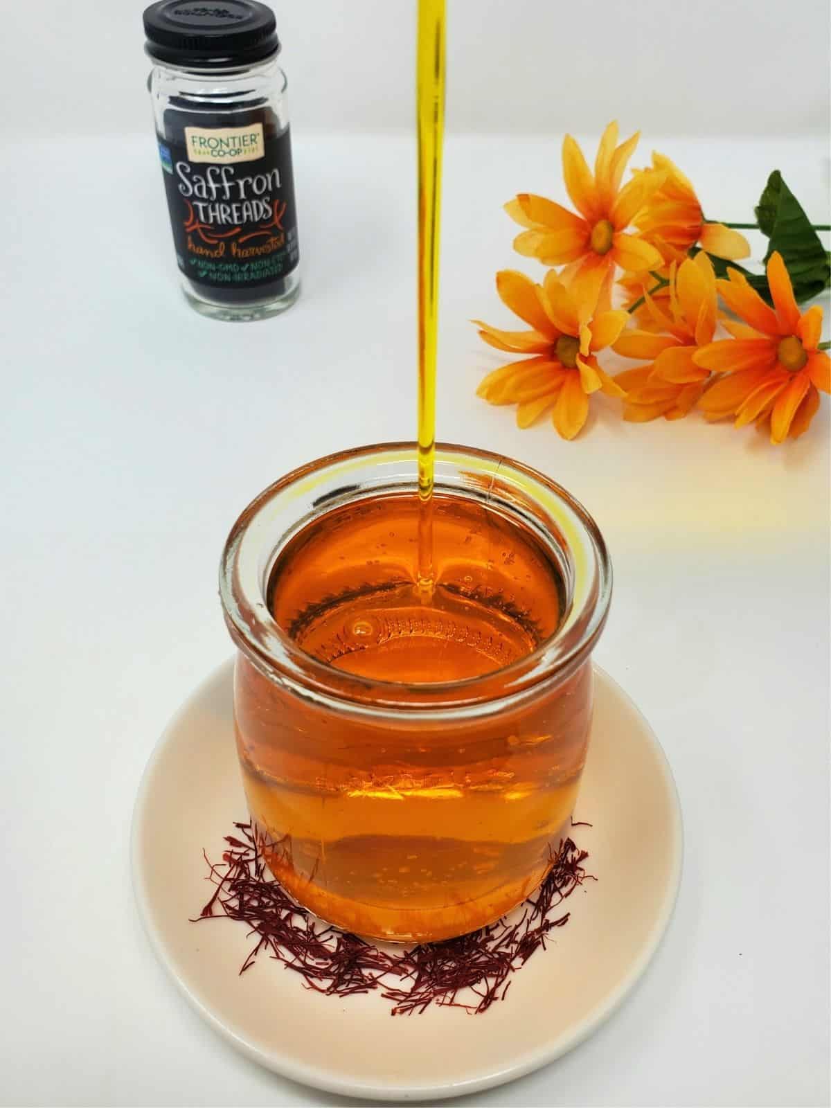 saffron syrup in a glass container.