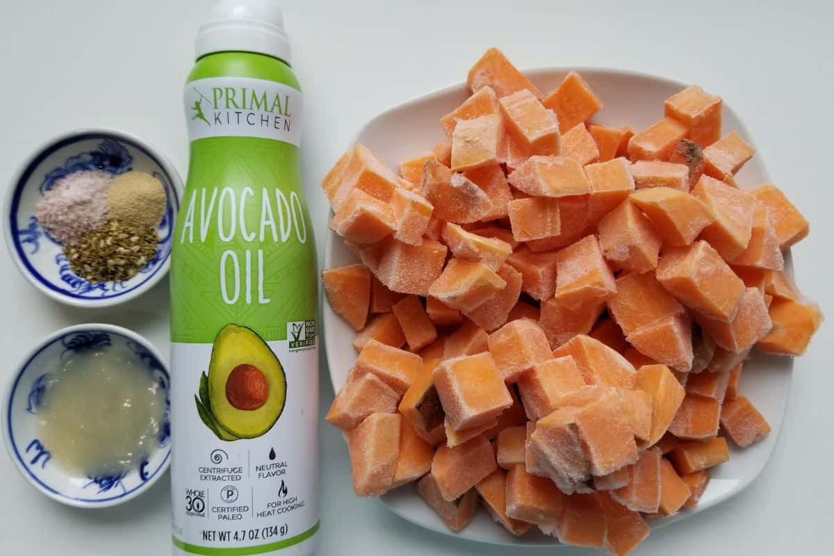 ingredients for air fryer sweet potatoes, including avocado oil, za'atar, sea salt, garlic, and sweet potatoes.