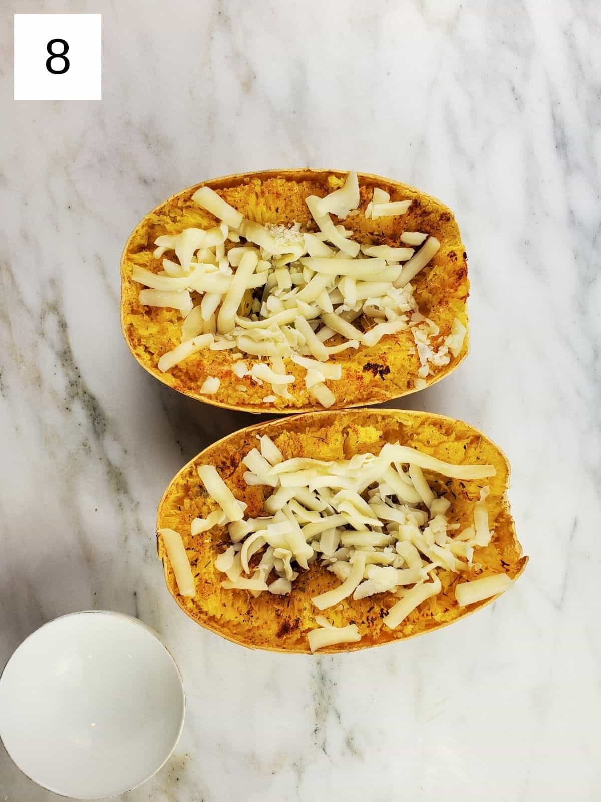 roasted seasoned spaghetti squash halves topped with mozzarella cheese.