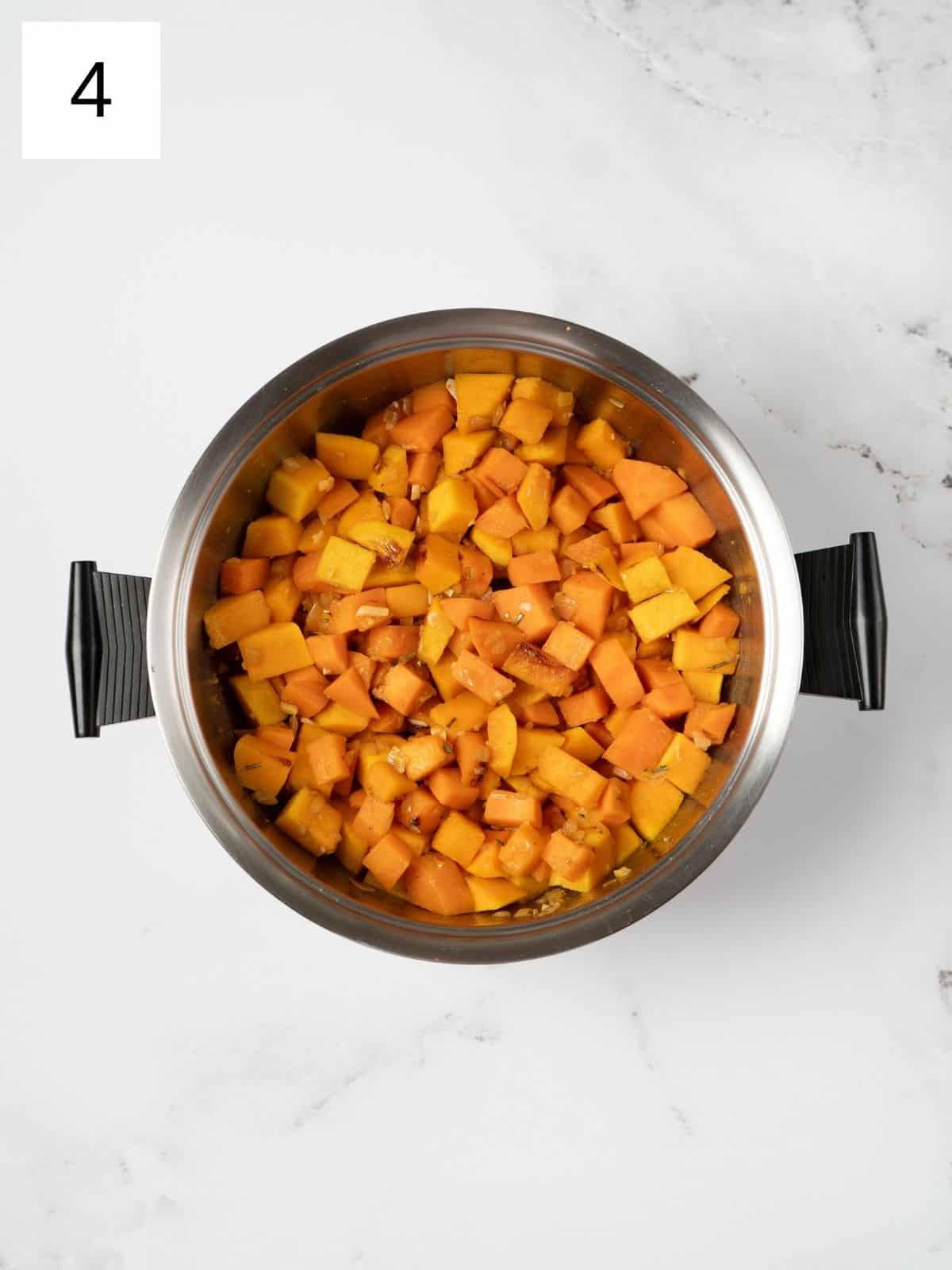 cubed butternut squash and sweet potato on a sautéed mixture of spices.