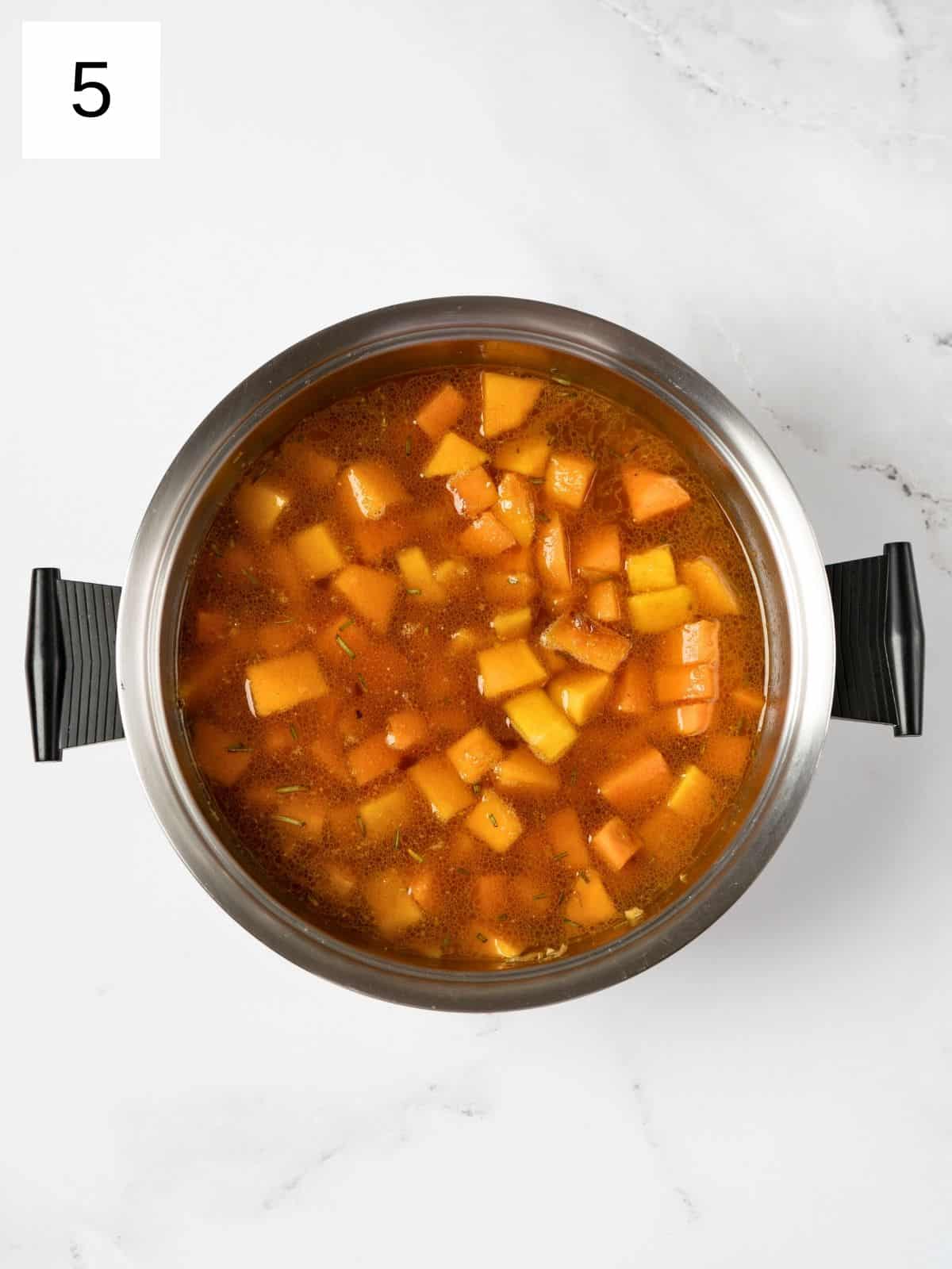 vegetable broth in a cooked squash and sweet potato mixture.